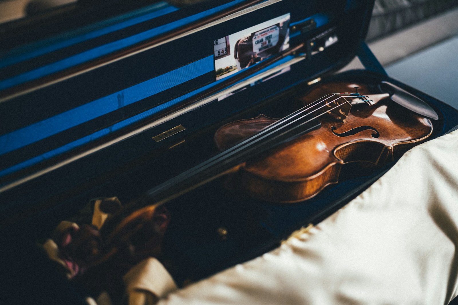 a violin sitting inside of an open suitcase