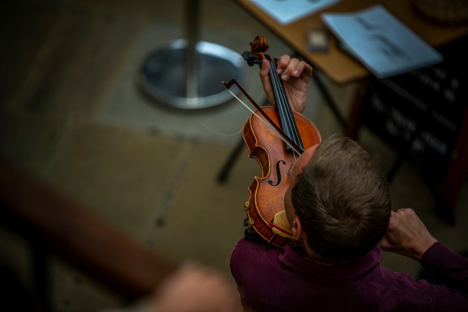 a man playing a violin in a room
